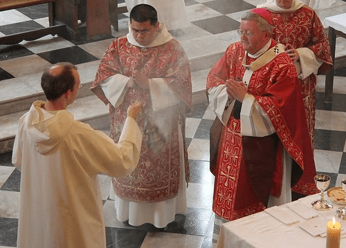 The priest, acting in the person of Christ, is incensed.
