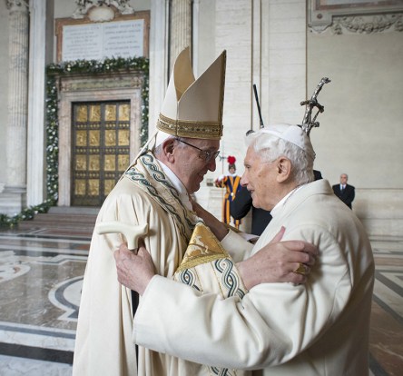 Pope Francis embraces Emeritus Pope Benedict XVI before opening the Holy Door to mark opening of the Catholic Holy Year, or Jubilee, in St. Peter's Basilica, at the Vatican